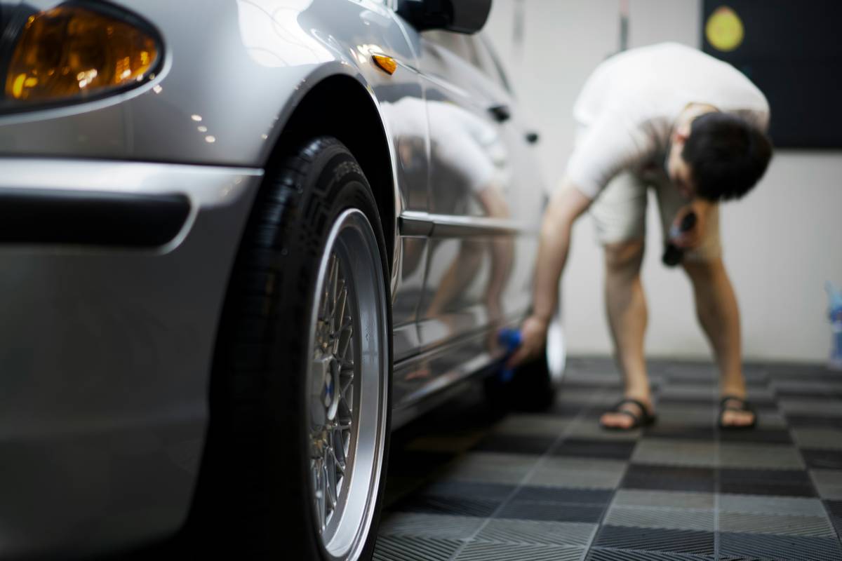 Mechanic inspecting car during pre-purchase evaluation for long-term car ownership over time planning