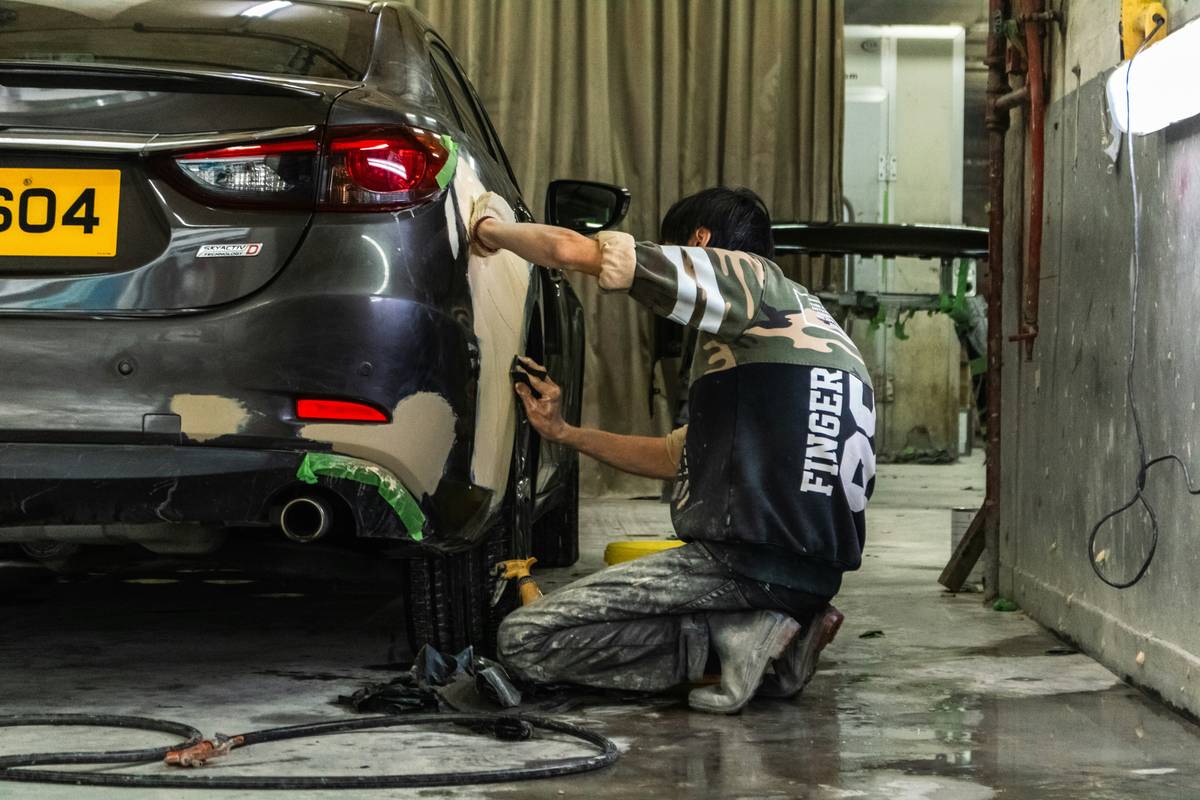 struts car repair diy showing compressed coil spring assembly on workbench