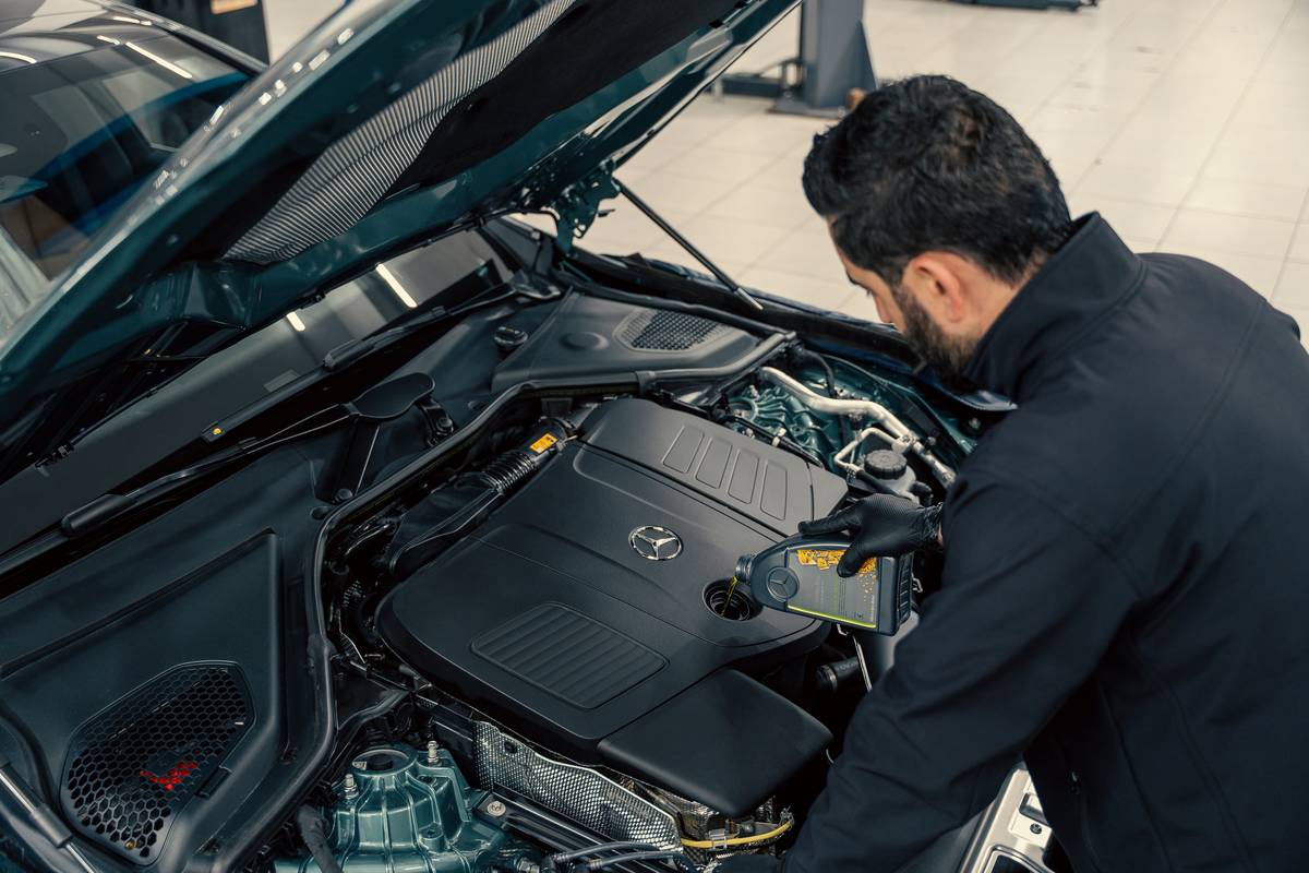 how to schedule routine car maintenance checklist on a clipboard next to car keys and oil bottle